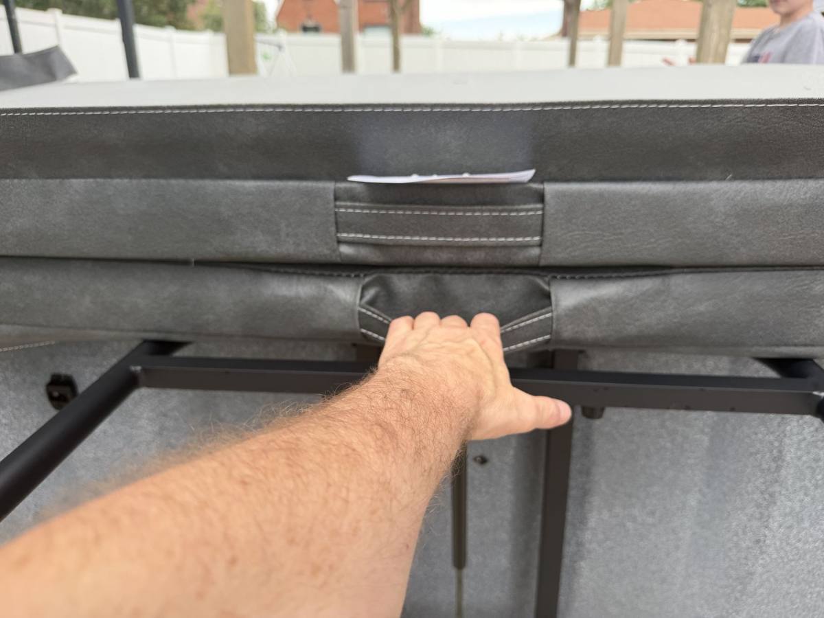 Using the stitched handle to lift and fold the hot tub cover