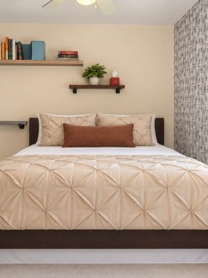 Bedroom 2 has a full bed and a wallpaper accent wall.